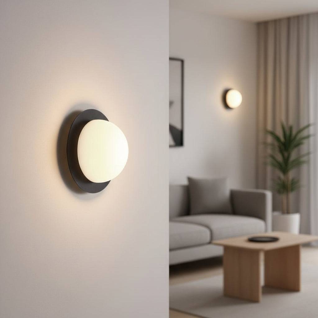 Black and white modern interior wall light on a white wall in a lounge with a plant