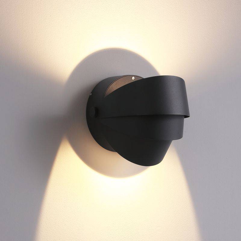 black modern outdoor wall lamp shown mounted on a white wall 