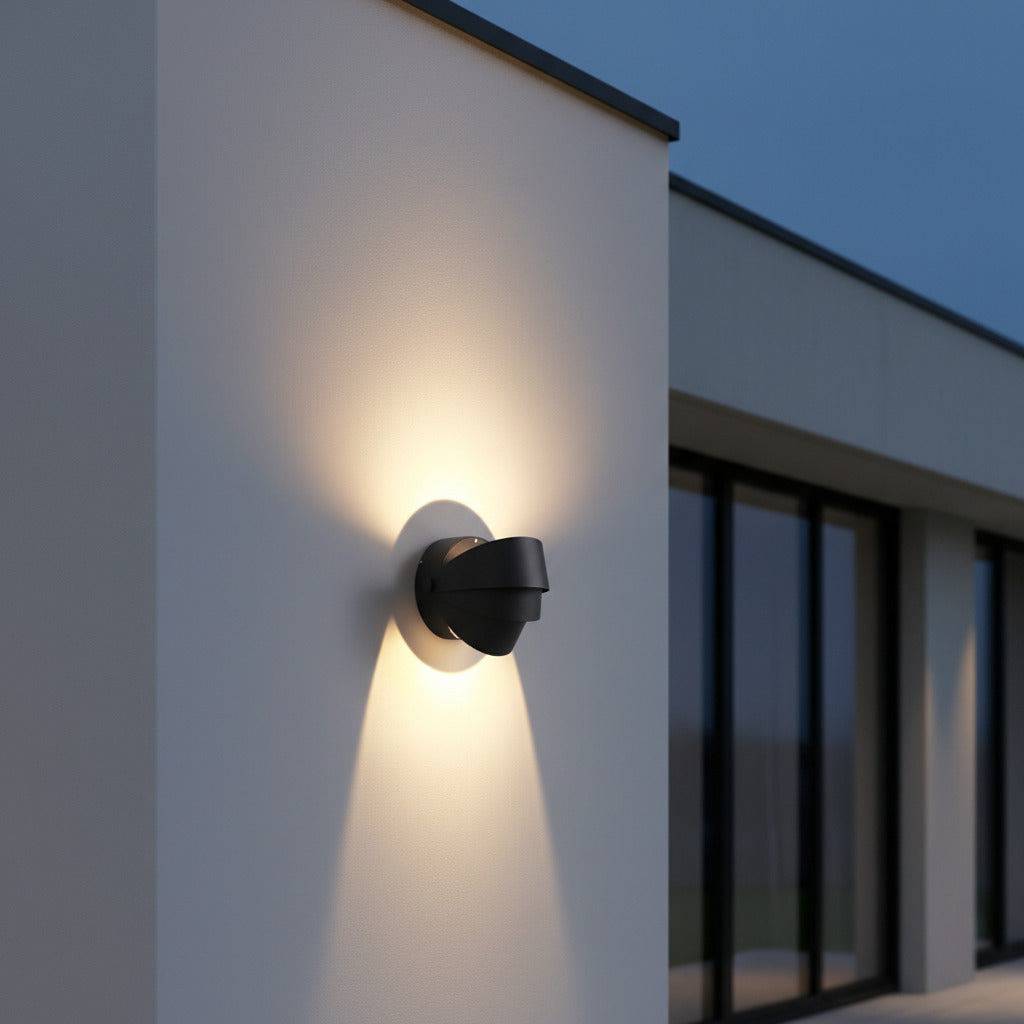black modern outdoor wall lamp mounted on a white wall outside of a modern house