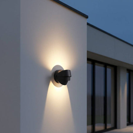 black modern outdoor wall lamp mounted on a white wall outside of a modern house