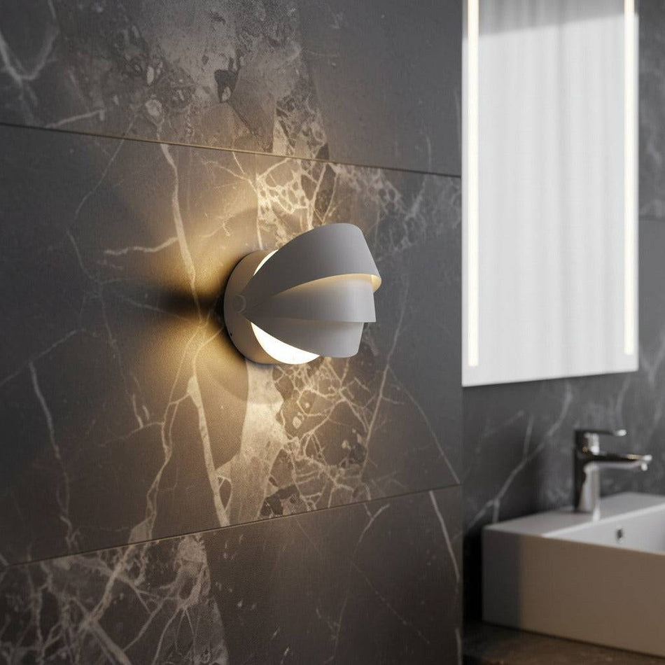 white bathroom wall light mounted on a dark marble wall in a modern bathroom 