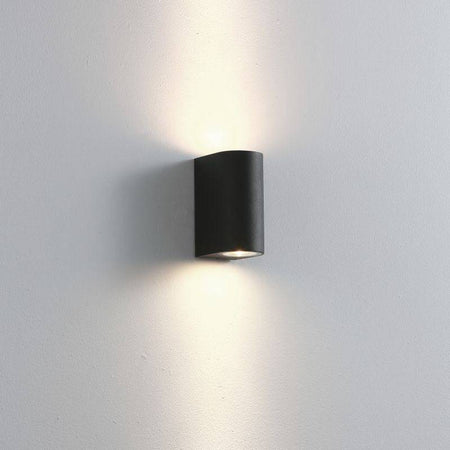 black outdoor up down light shown on a white wall 