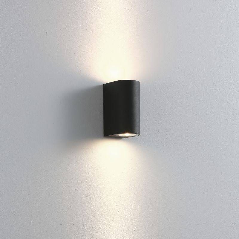 black bathroom wall mount light fitting shown mounted on a white wall 
