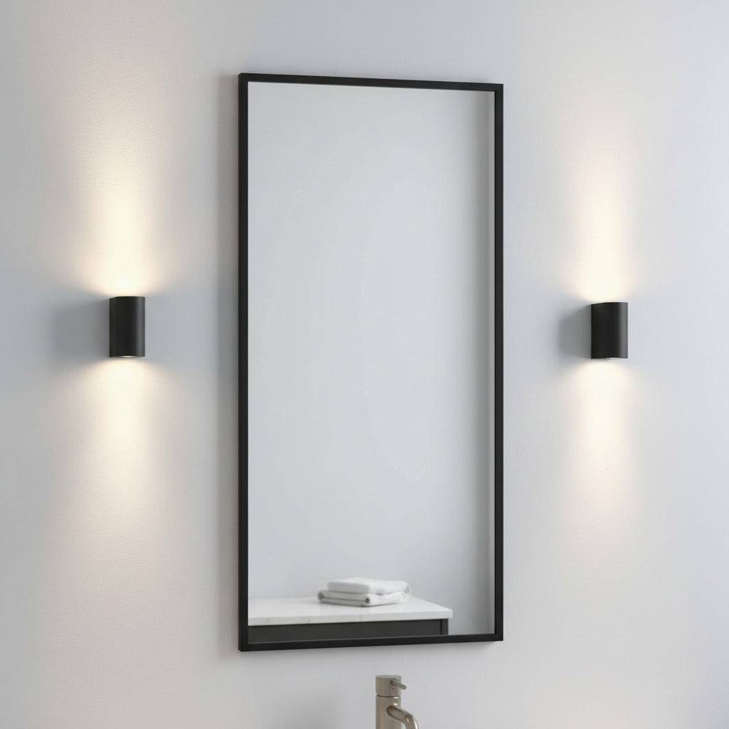 black bathroom wall mount light fitting mounted either side of a bathroom mirror