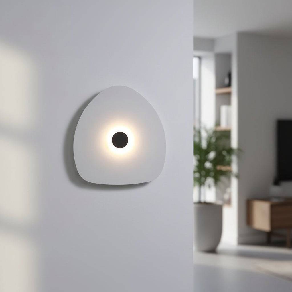 Modern internal wall light white finish with a black halo dot to the centre in a modern home setting