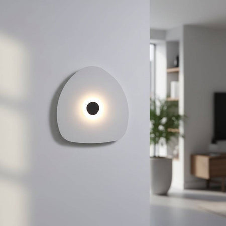 Modern internal wall light white finish with a black halo dot to the centre in a modern home setting