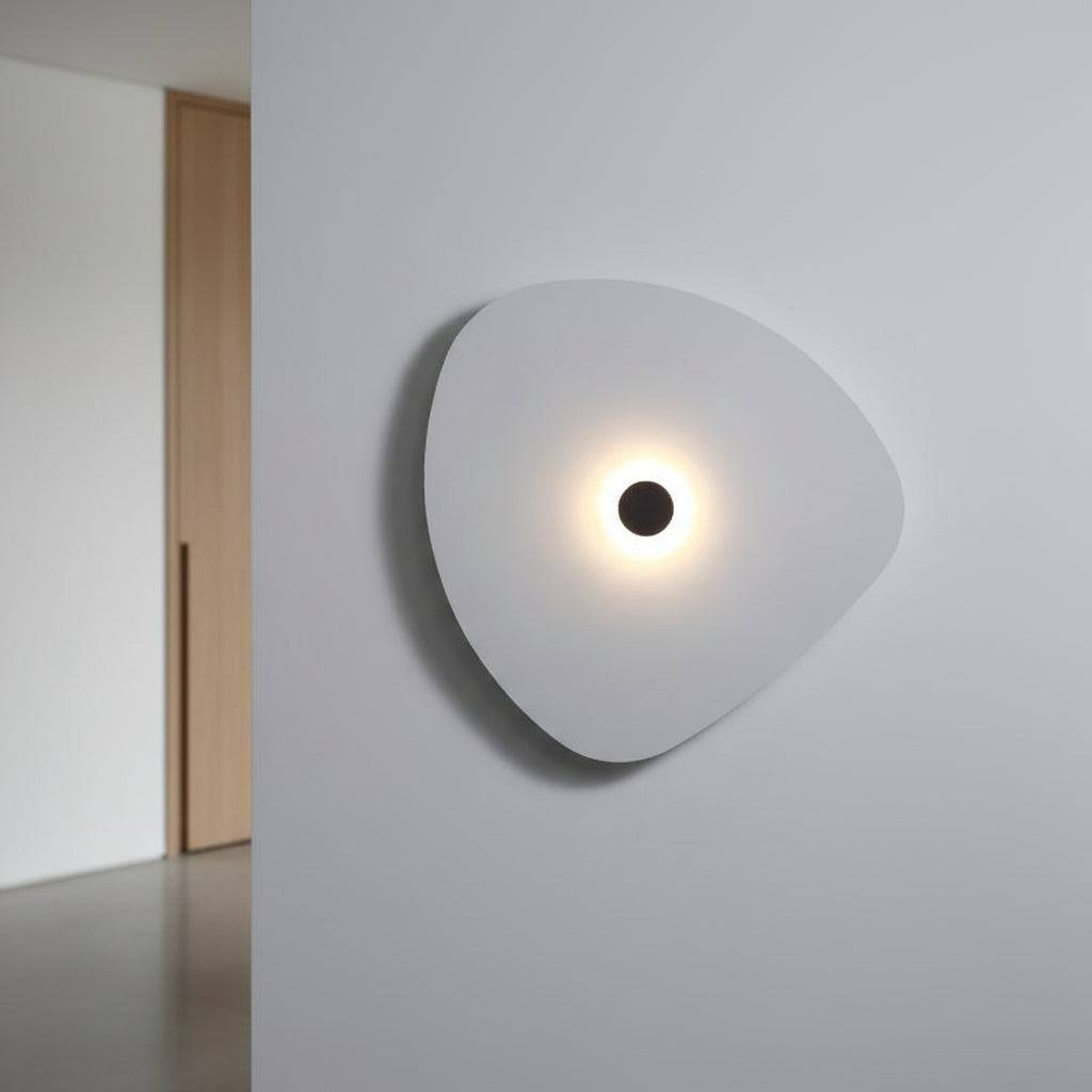 White indoor decorative wall sconce on a grey wall in  a modern home