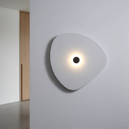 White indoor decorative wall sconce on a grey wall in  a modern home