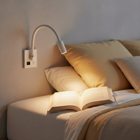 white reading lamp with USB port mounted over a bed