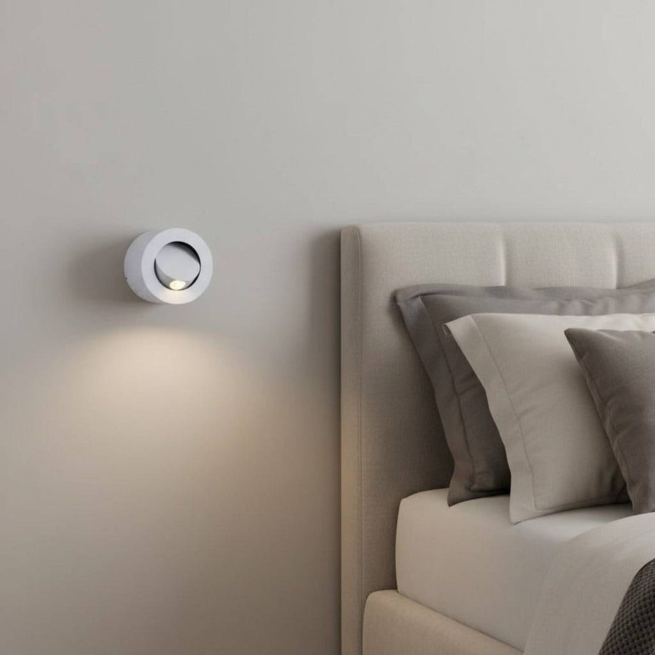 white bedside lamp for reading mounted on the wall next to the bed in a minimalist bedroom