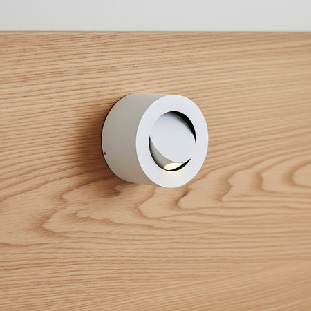 white adjustable bed lamp for reading mounted on a wooden bed headboard