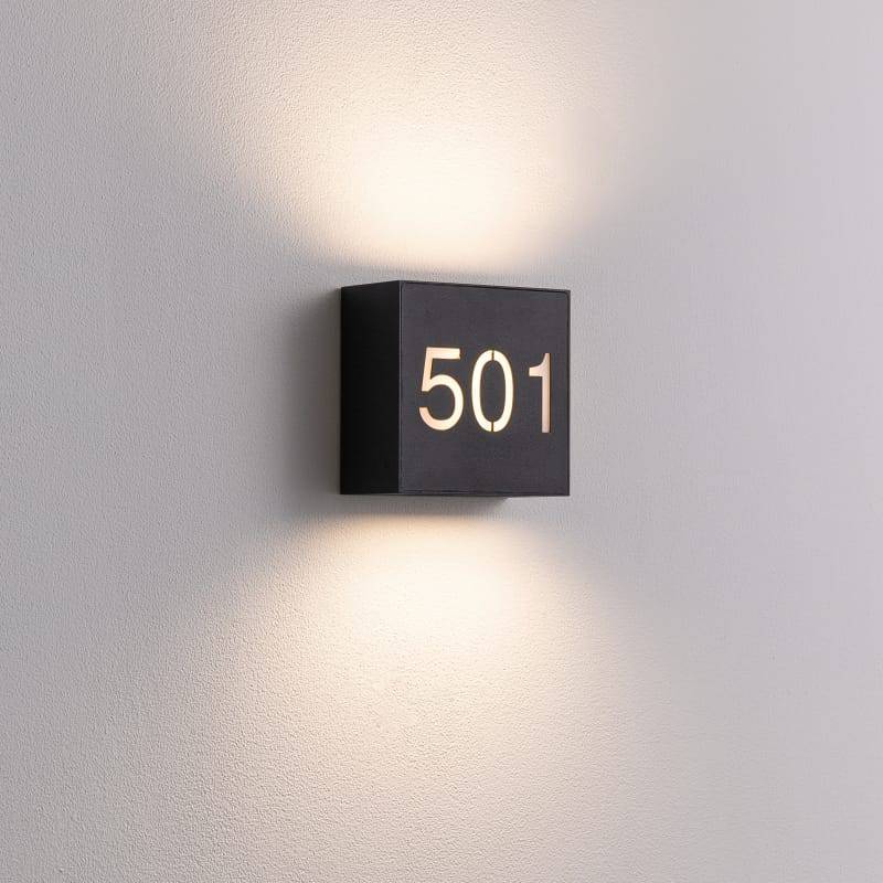 black backlit house number sign shown on a white wall 