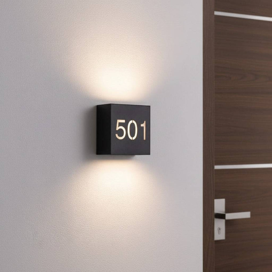 black backlit house number sign outside of a modern house next to the front door