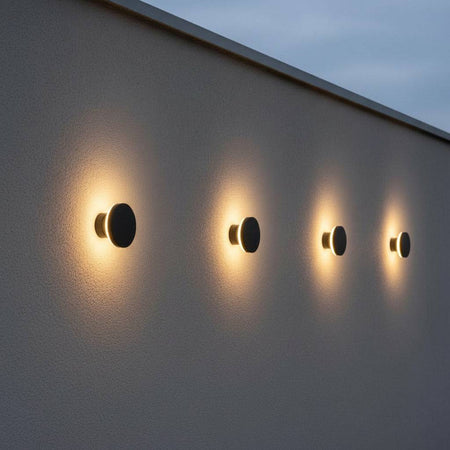 black exterior wall mount light showing 4 lights in a row on a white textured exterior wall 