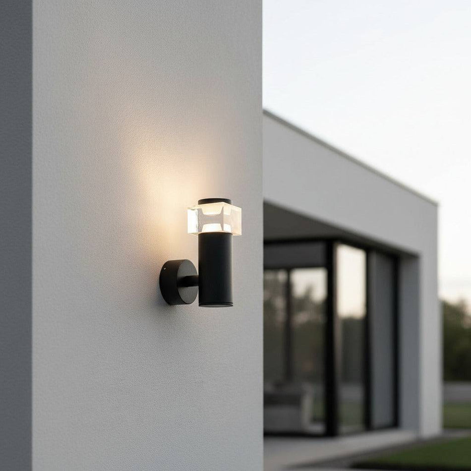 black outside wall sconce mounted on the outside wall of a modern house the wall is white 