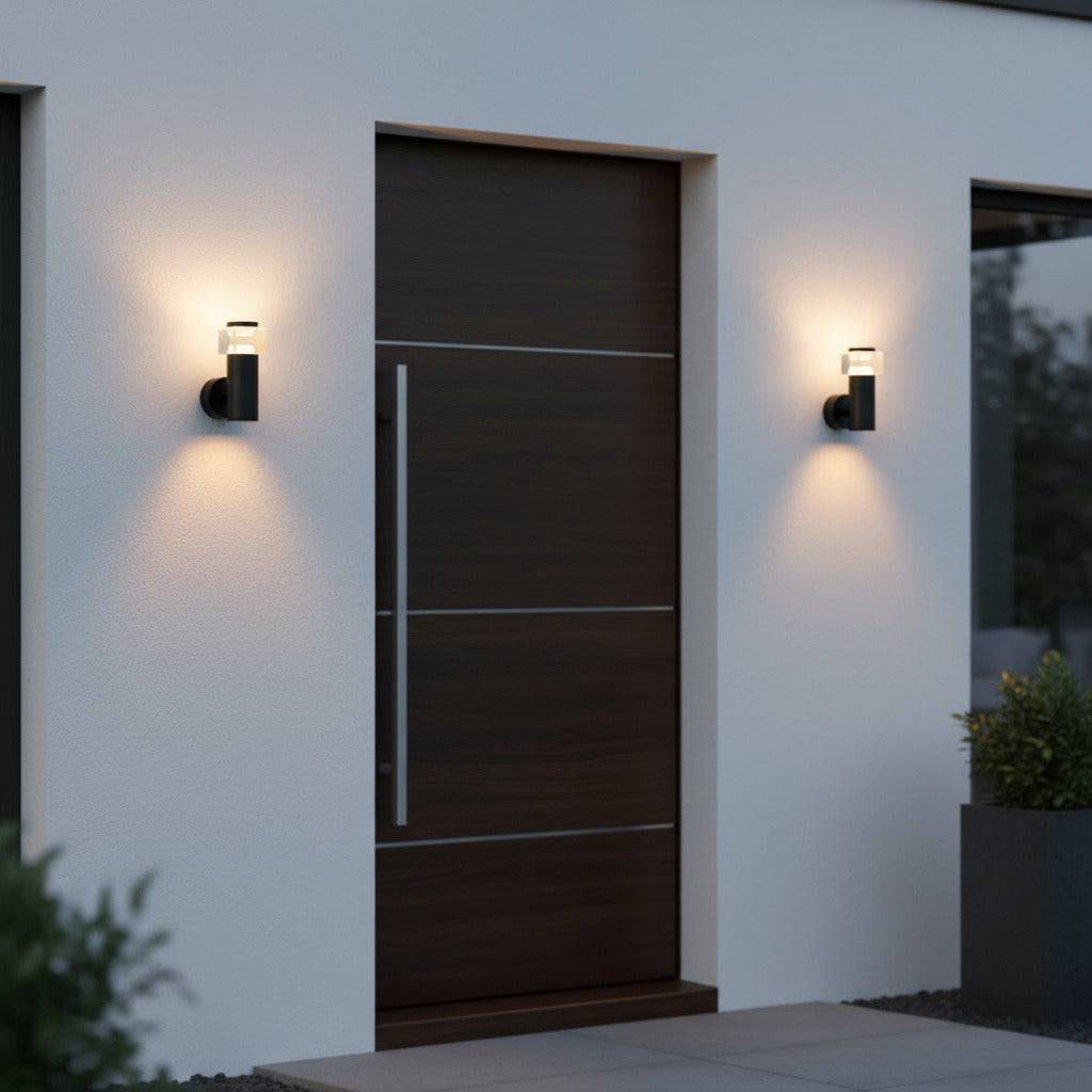 black outside wall sconce mounted either side of the front door of a modern home 