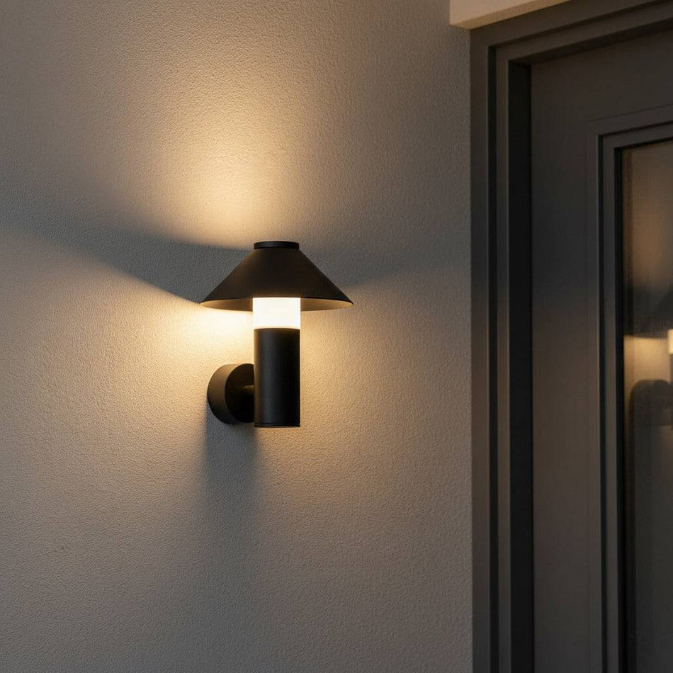 black outdoor lantern light mounted on a white wall next to the front door of a house