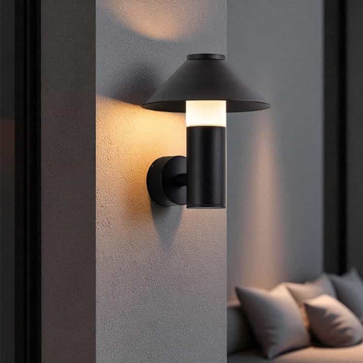 black outdoor lantern light mounted on a white textured wall outside of a modern home