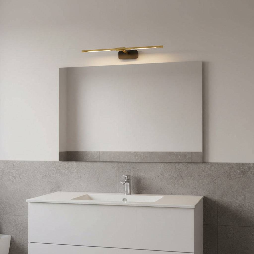 gold modern bathroom light over mirror in a modern bathroom 