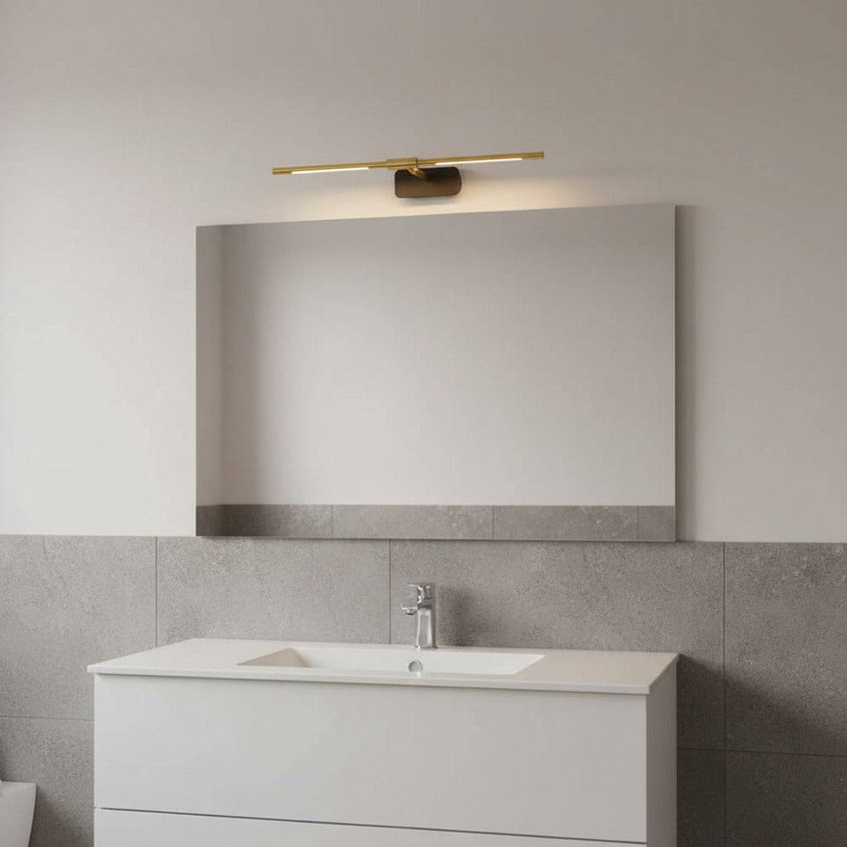 gold modern bathroom light over mirror in a modern bathroom 