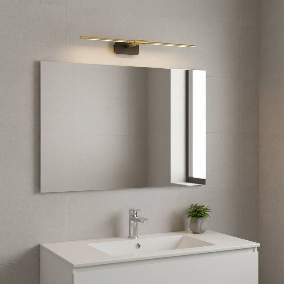 gold wall mirror LED light mounted over a bathroom mirror in a modern bathroom