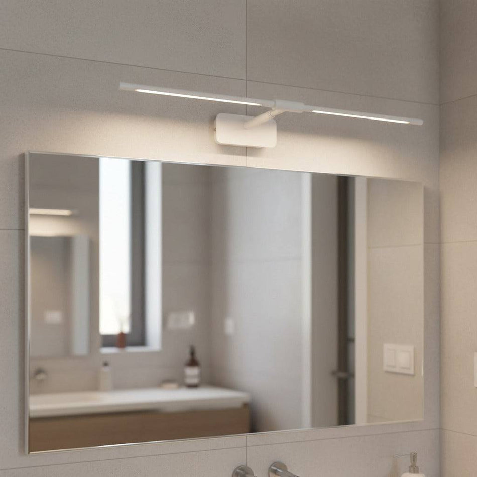 white above mirror vanity light mounted on the wall in a modern bathroom