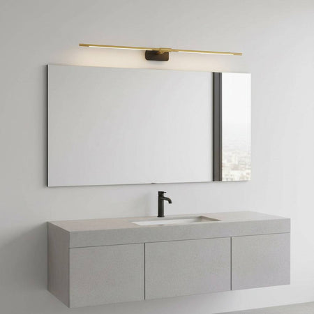 gold bathroom mirror light fixture mounted on the wall over a mirror in a modern bathroom