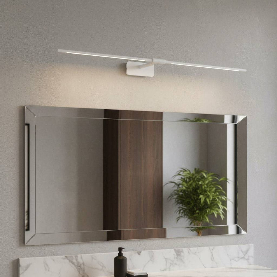 white bathroom light fixture over mirror in a modern bathroom