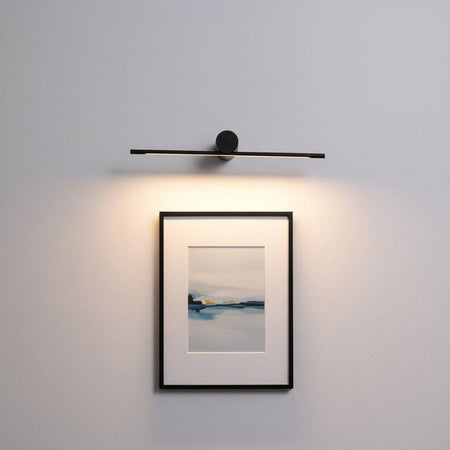 black picture light shown mounted on the wall over a picture