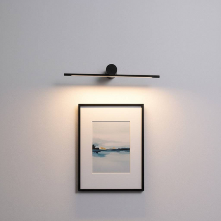 black picture light shown mounted on the wall over a picture