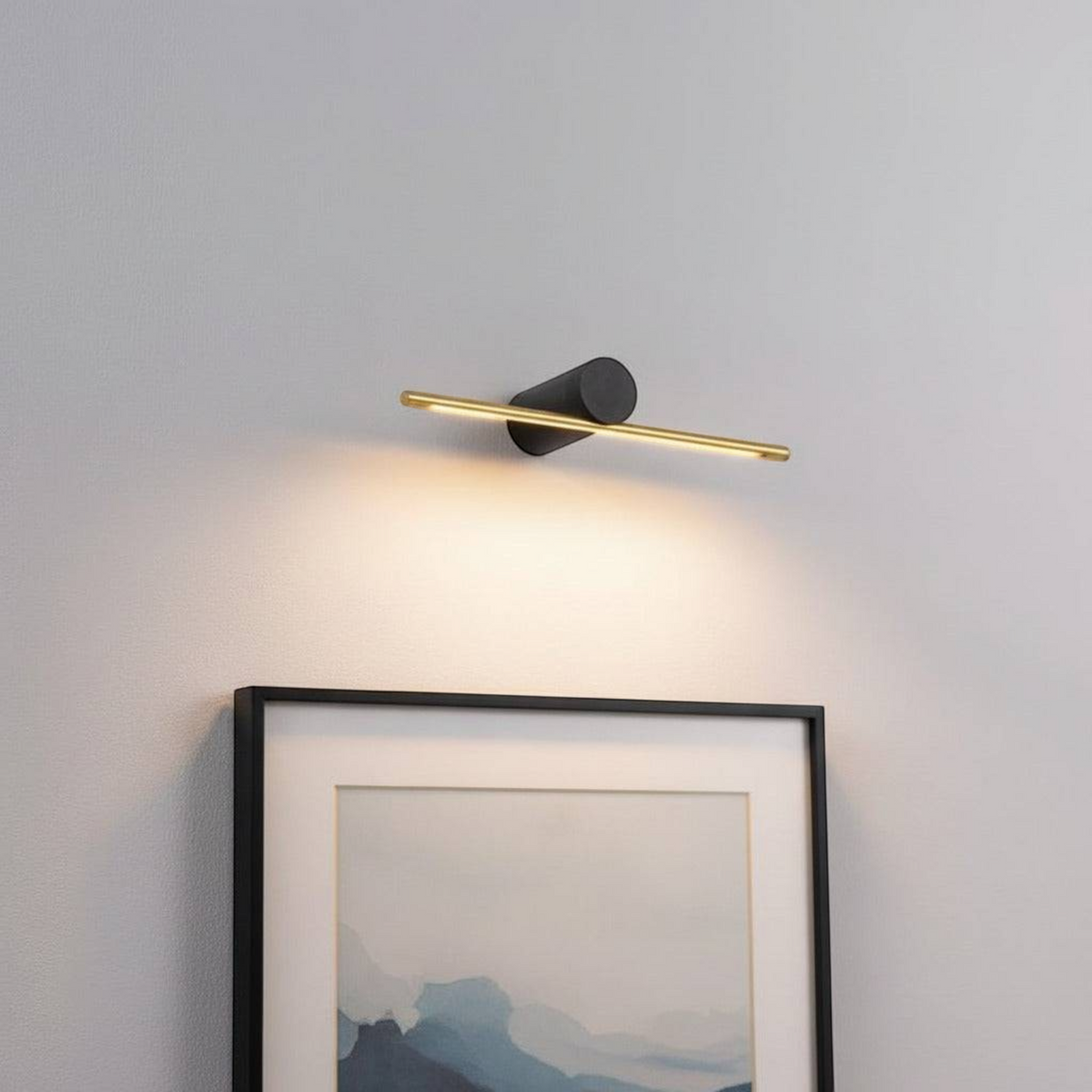 gold small picture light mounted on the wall over a picture