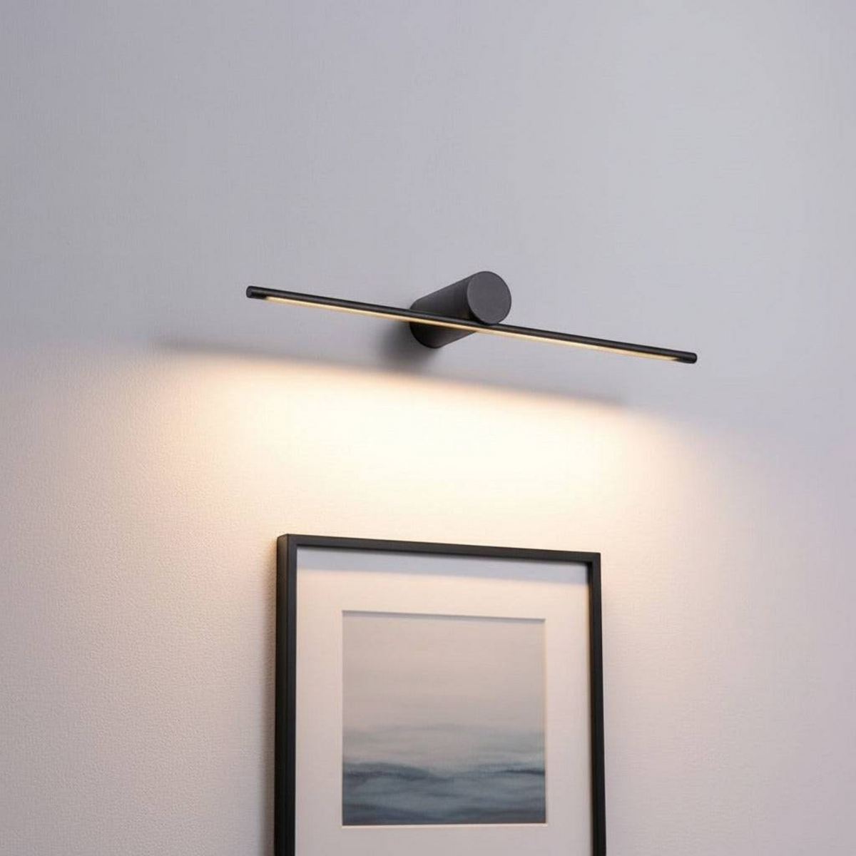 black over picture light mounted above artwork on the wall