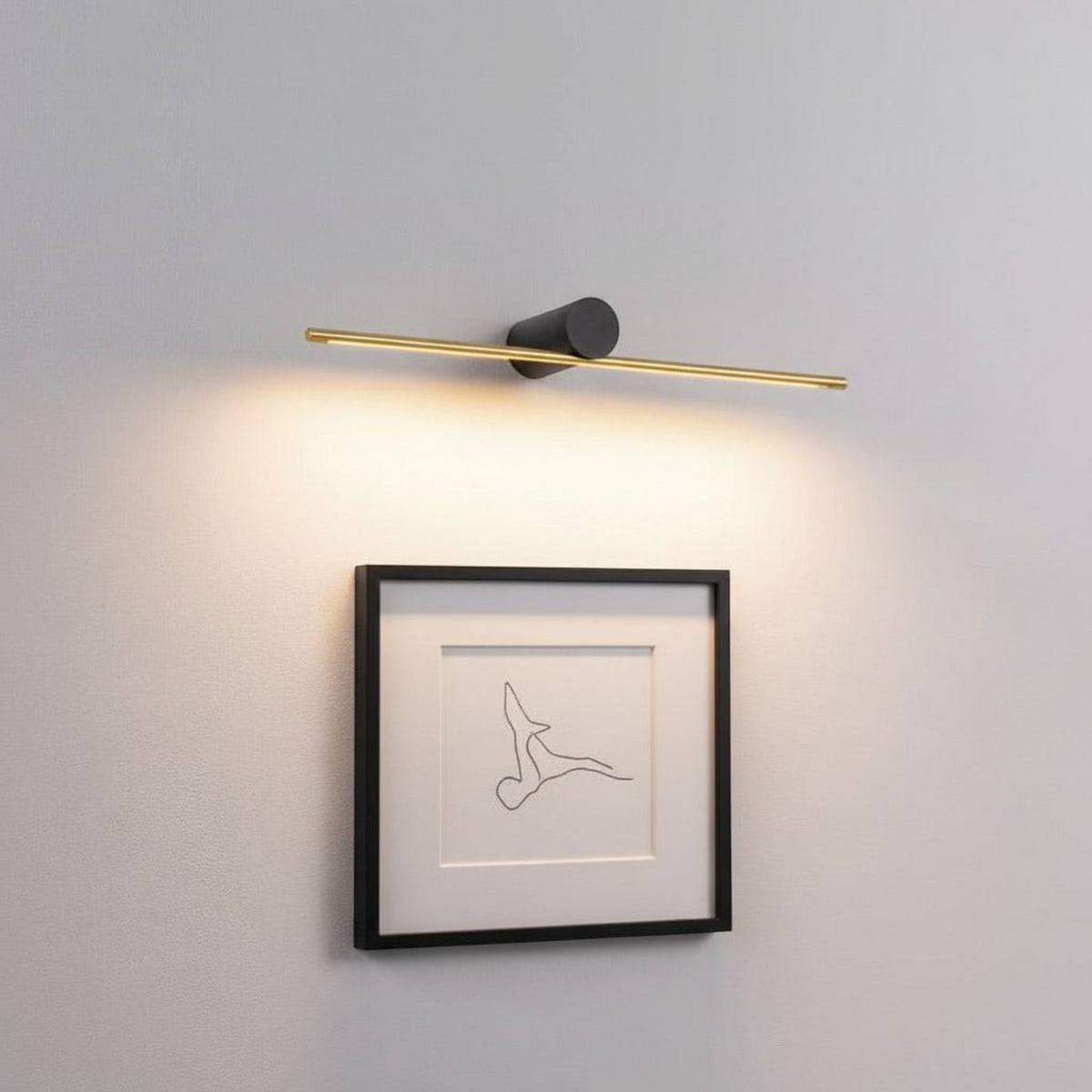 gold picture light fixture mounted on the wall over some modern artwork