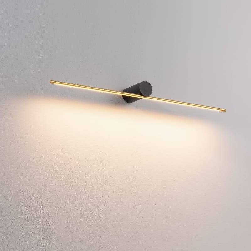 gold LED picture lamp mounted on a white wall