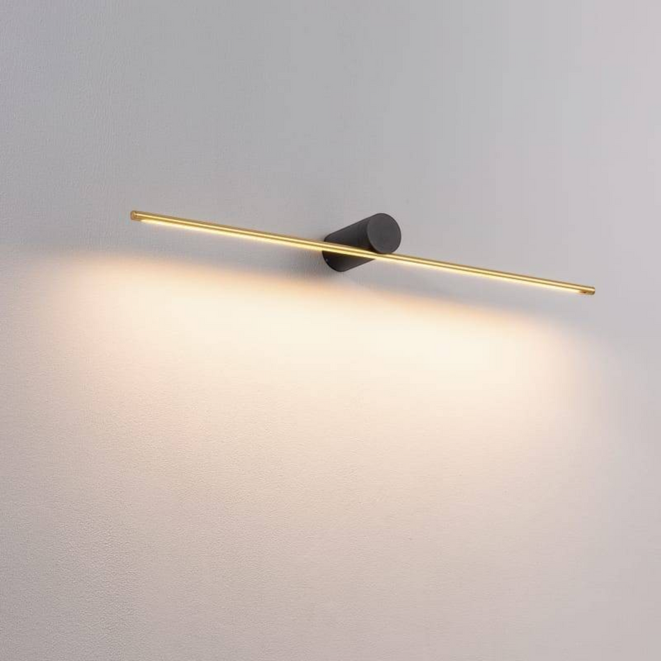 gold LED picture lamp mounted on a white wall