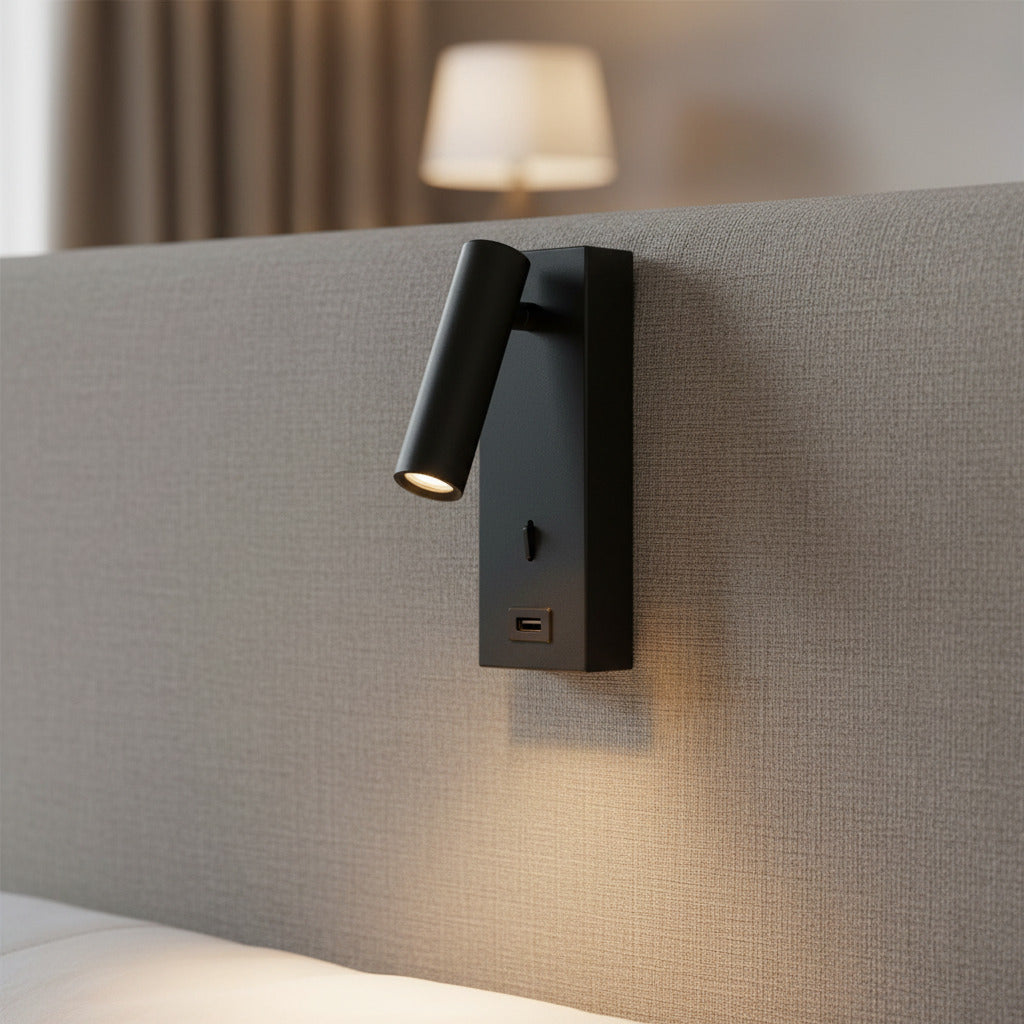 black wall mounted reading light with USB port mounted on a fabric headboard