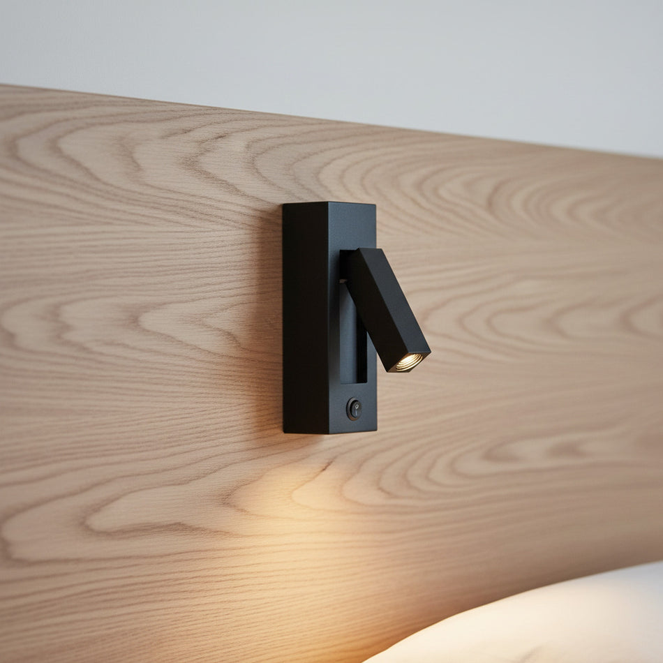 black wall mounted reading lamp mounted on a wooden bed headboard 