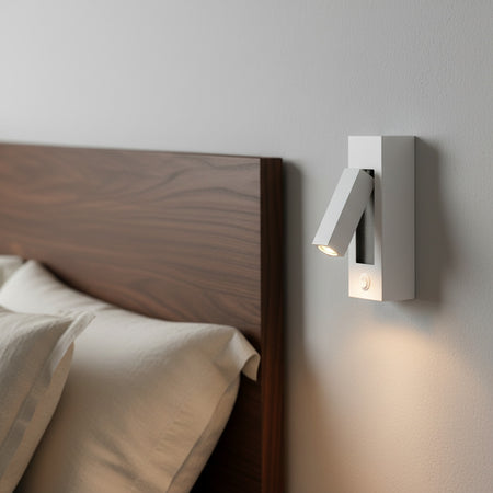 white wall mounted reading light on the wall next to a bed