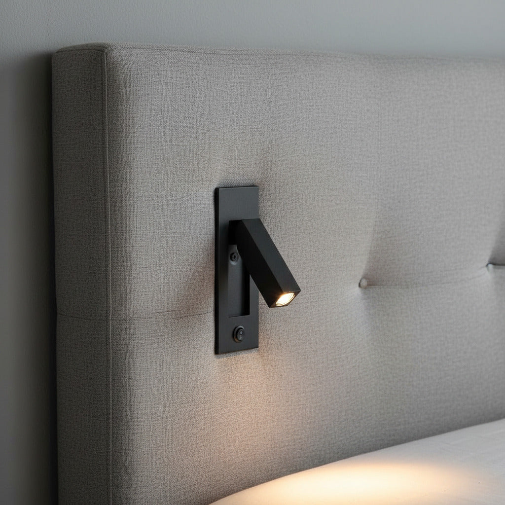 black adjustable recessed bedroom reading light mounted on a fabric headboard 