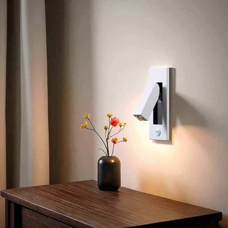 white recessed bedroom reading lamp mounted over a bedside table in a bedroom