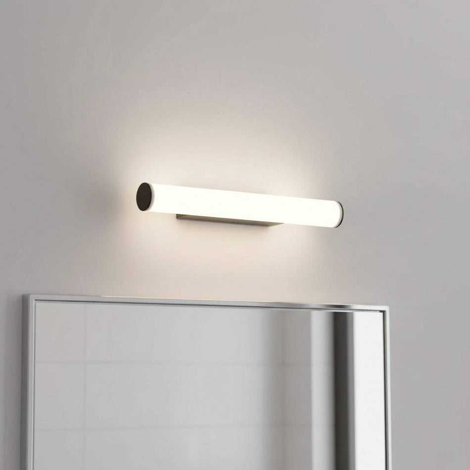 black LED bathroom mirror light mounted over a mirror in a modern bathroom