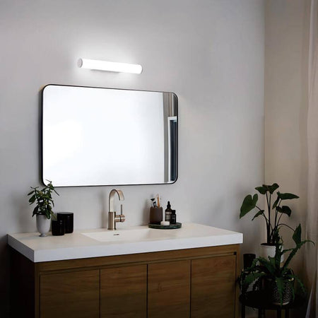 white bathroom mirror wall light mounted over the top of a bathroom mirror