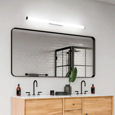 black mirror wall light mounted over a bathroom vanity unit in a modern bathroom