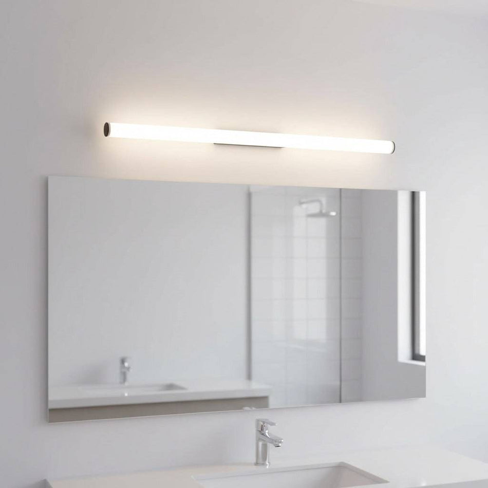black tubular bathroom sconce mounted over a mirror in a modern bathroom