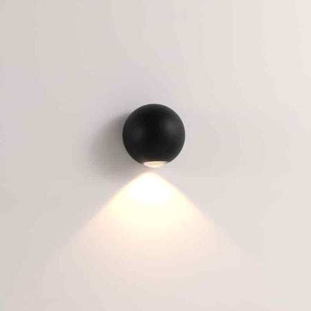 black outdoor downlight wall light mounted on a white wall 