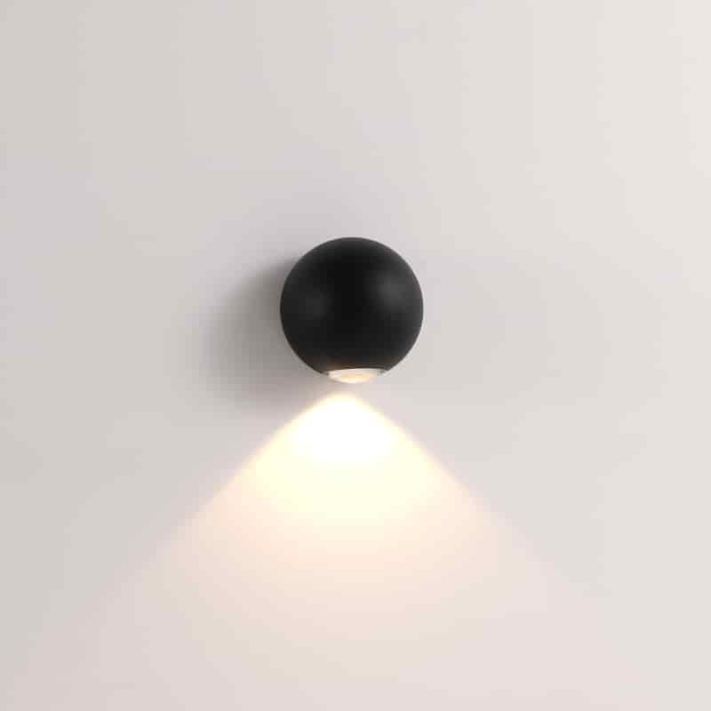 black outdoor downlight wall light mounted on a white wall 