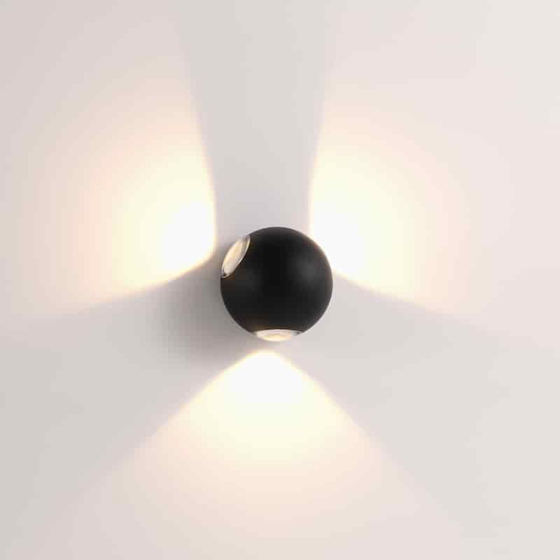 black outdoor sconce wall light shown mounted on a white wall 