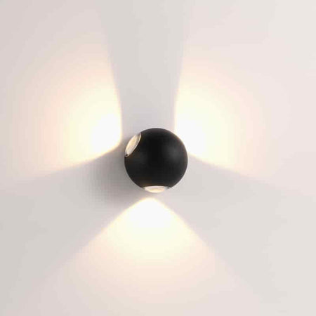 black outdoor sconce wall light shown mounted on a white wall 