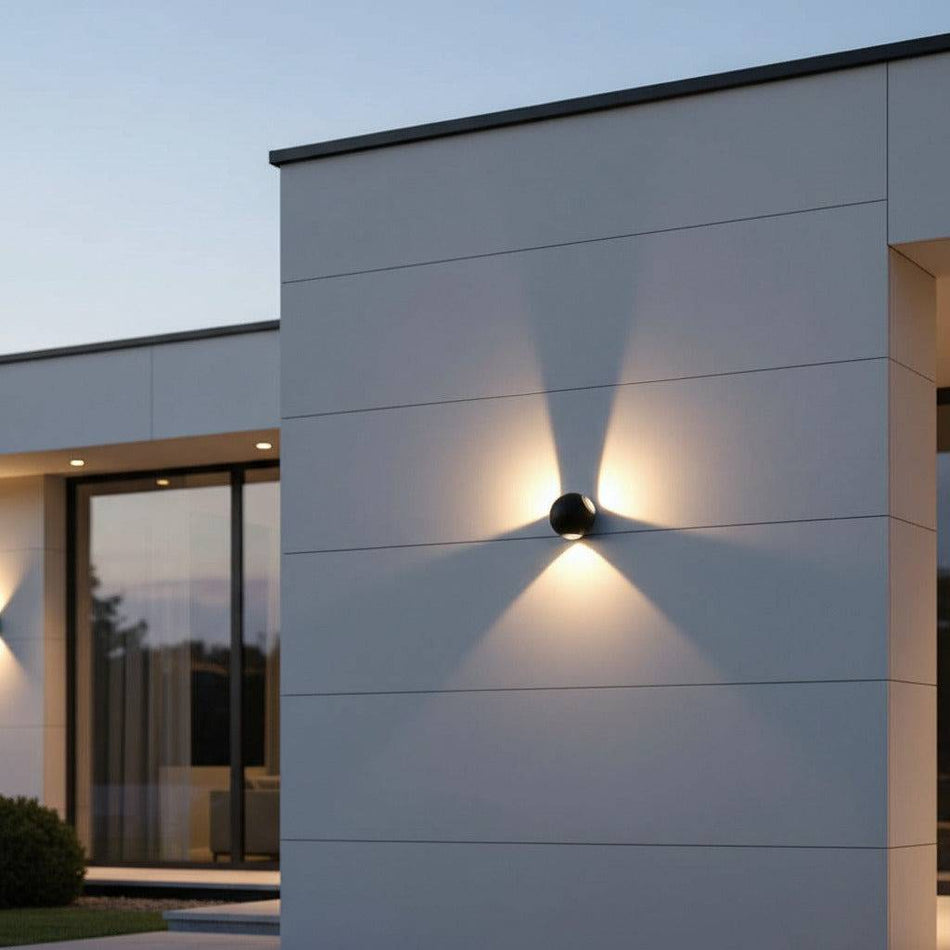 black outdoor sconce wall light mounted on the exterior wall of an ultra modern home 