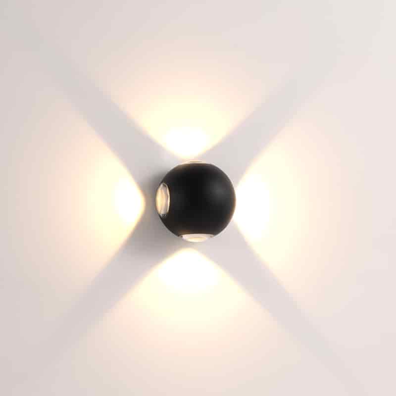 black outside wall light fixture shown mounted on a white wall 